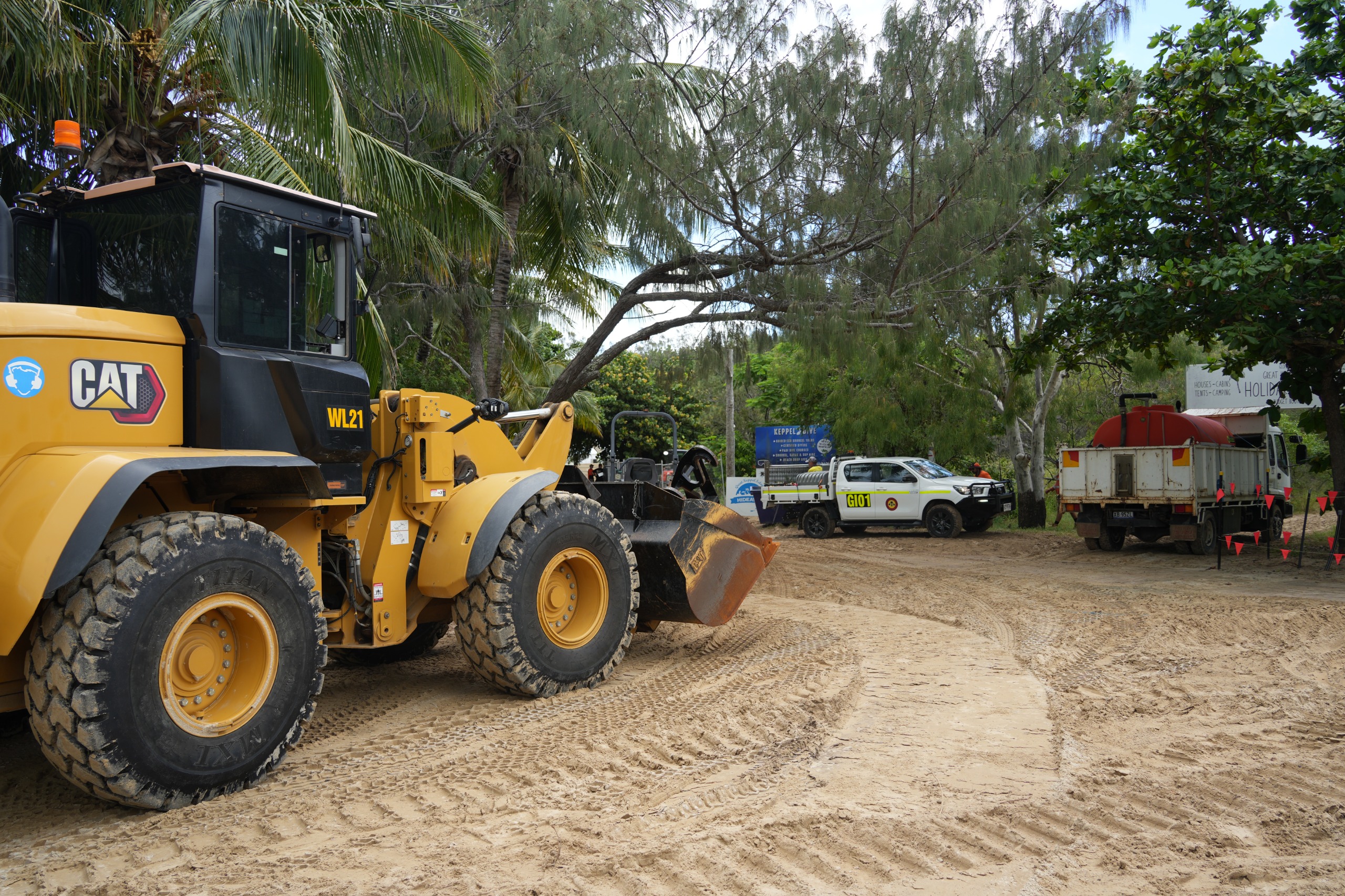 Image of a bulldozer and water truck on location at Great Keppel Island