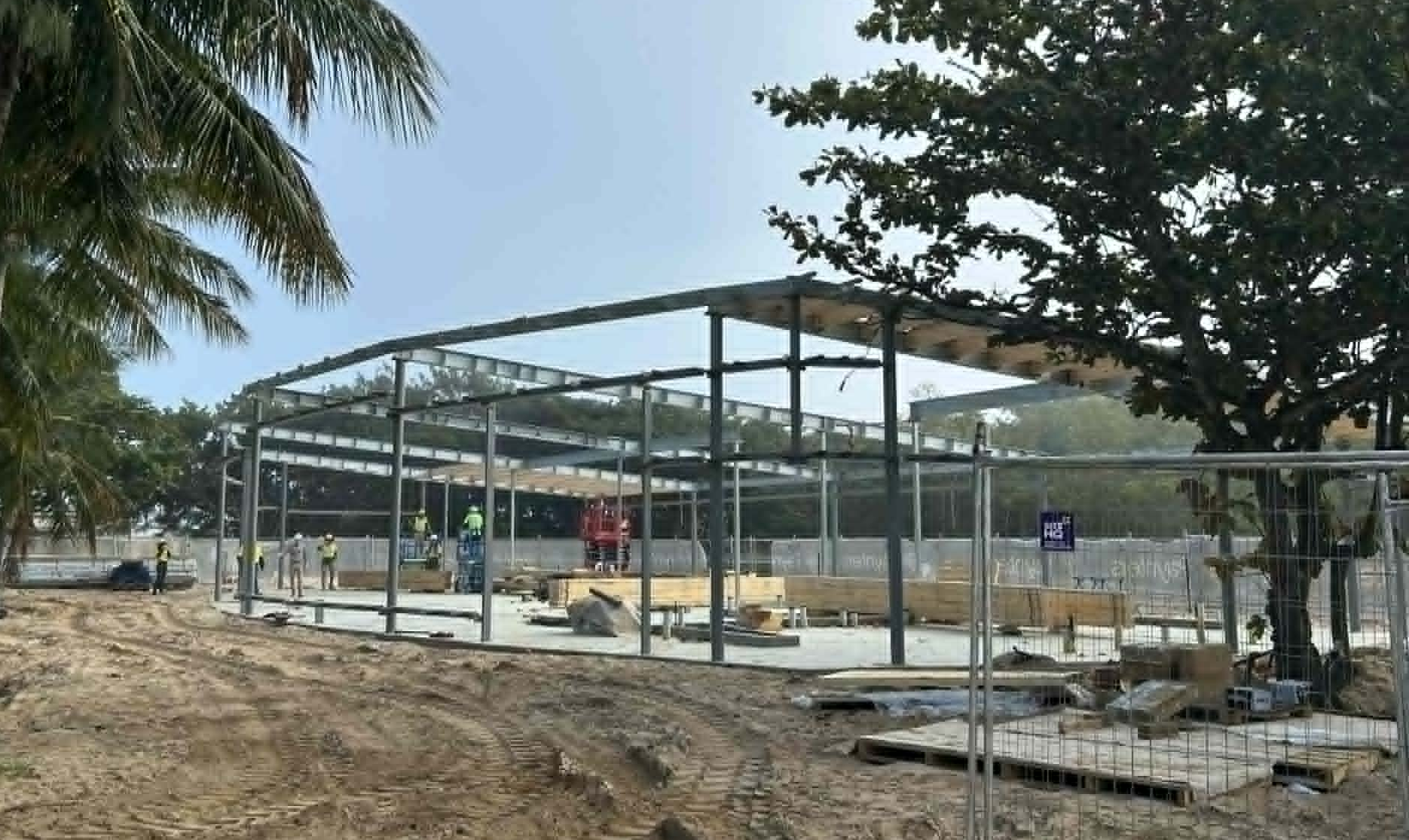 Structural steel beams and a large concrete slab on location at the site of the new Arrivals Plaza. 