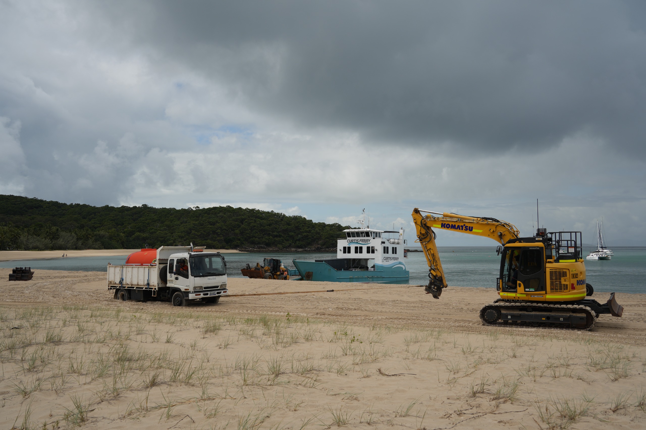 Image of a water truck being towed along Fishermen's Beach